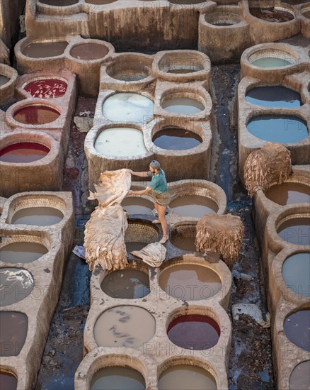 Worker dyeing leather