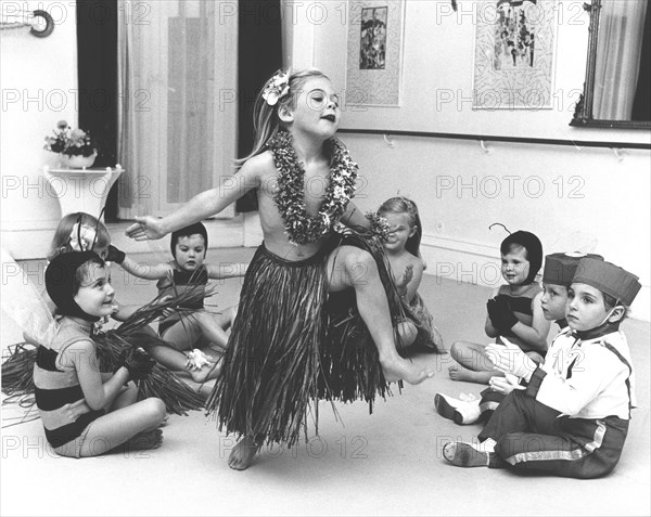 Girl with raffia skirt dances