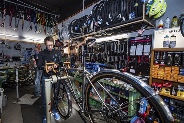 Man repairs bicycle