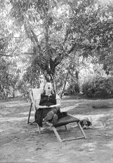 Grandma yawns in a deck chair in the garden