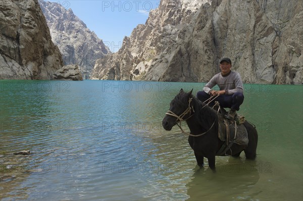 Kyrgyz showing his agility on his horse in Kol-Suu lake