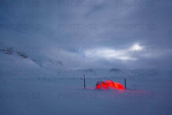 Tent by full moon in the snow