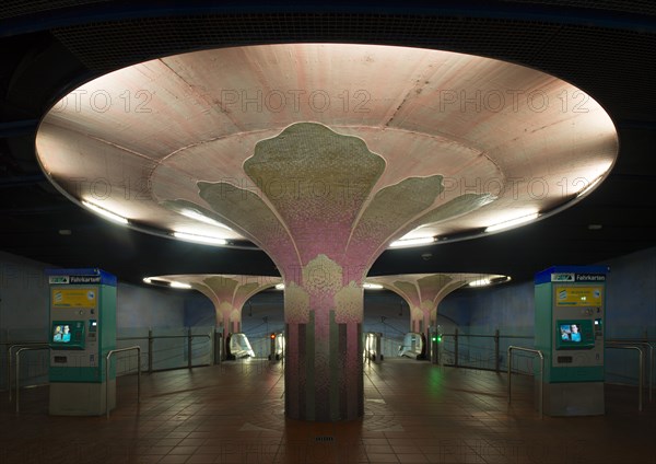 Illuminated column in entrance hall with ticket machine