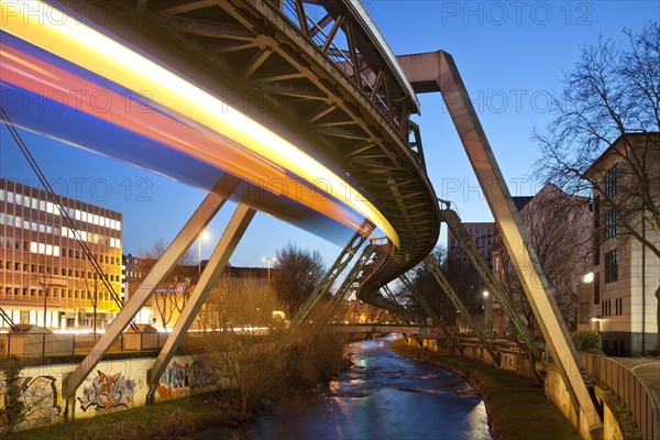 Trail of light from a moving suspension railway above the Wupper