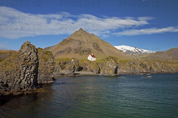 House on the basalt coast off Stapafell mountain and Snaefellsjoekull glacier