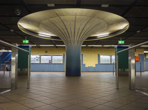 Illuminated column in entrance hall with ticket machine