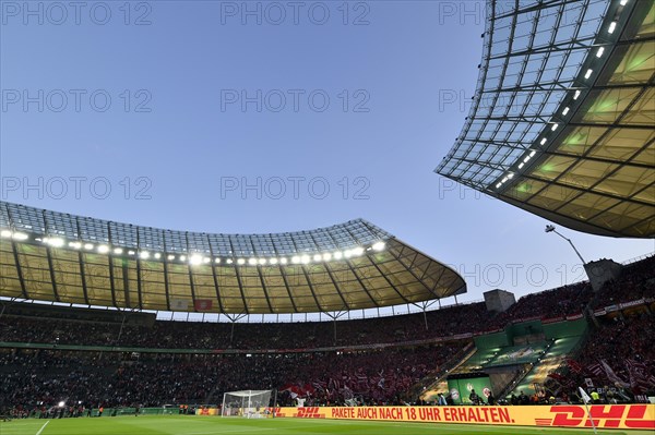 Football stadium illuminated with perimeter advertising