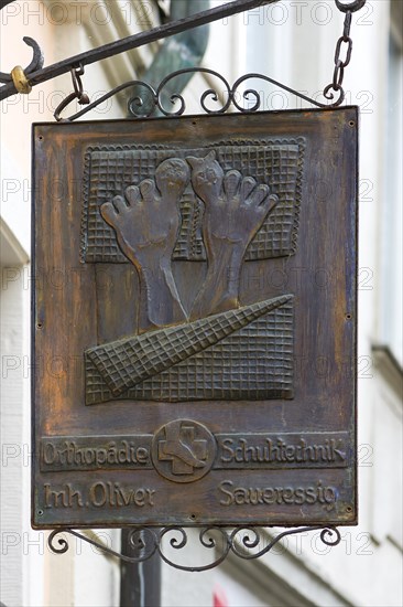 Old hanging shop sign from an orthopedic shoe store