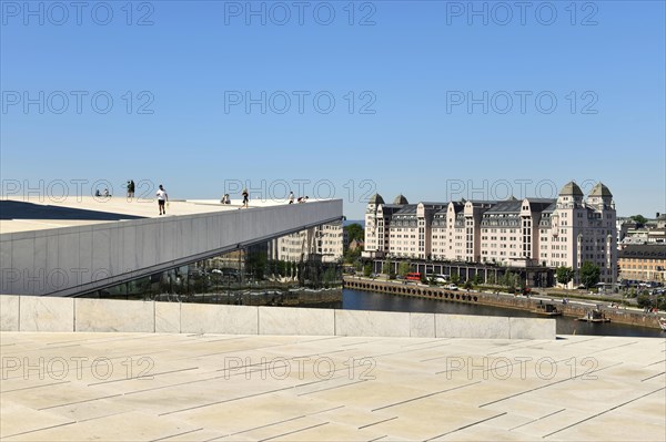 Forecourt and walk-in roof of the new white marble opera house in the back old warehouse district with harbour warehouse