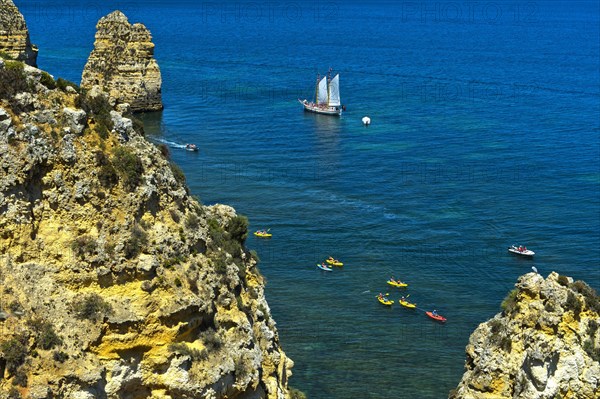 Sailing ship and sea kayaks off Camilo Beach