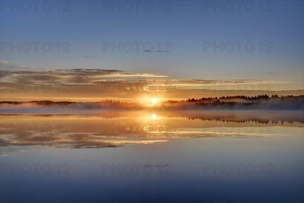 Sunrise with early morning mist over Kirchsee