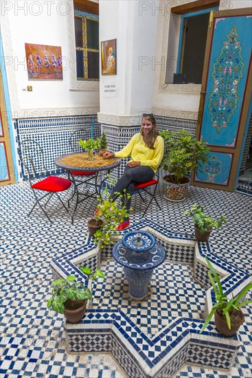 Young woman in a Moroccan courtyard