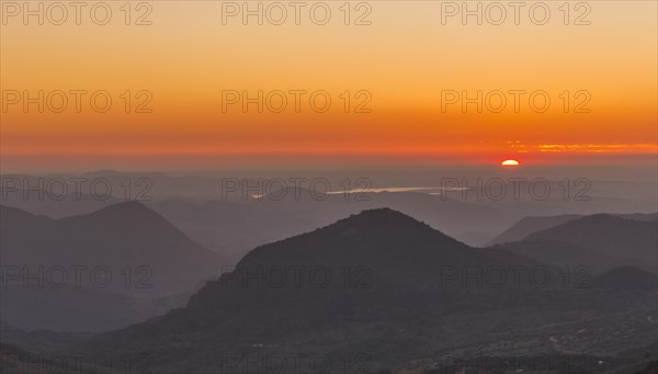 Wooded mountain landscape at sunset