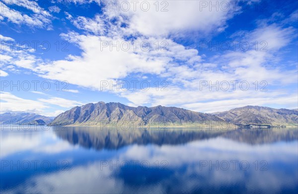 Cloudy sky with water reflections in Lake Hawea