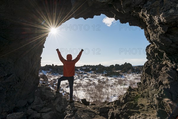 Man stretches arms in the air