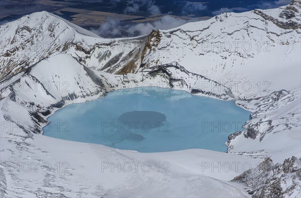 Aerial view of a tuquoise crater lake on top of Mount Ruapehu
