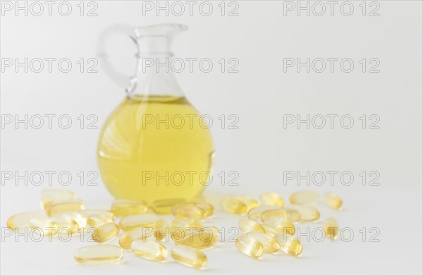 Omega 3 fish oil capsules and bottle on white background