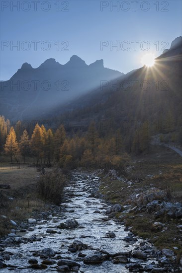 Backlit torrent and mountains