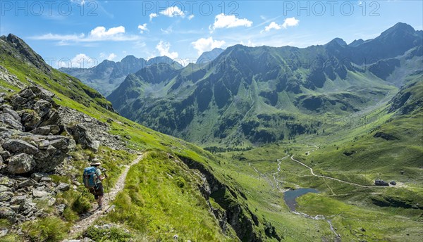 Hiker on the Schladminger Hohenweg on the descent to the Keinprechthutte Schladminger Tauern