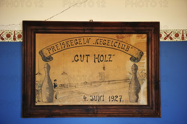 Shield of the former skittles club hanging on a wall in the former diamond town