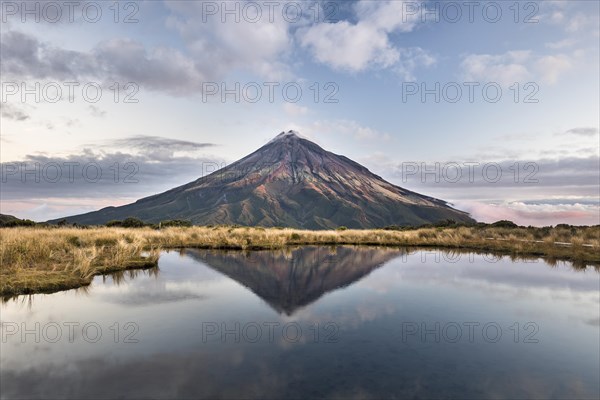 Stratovolcano Mount Taranaki or Mount Egmont reflected in Pouakai Tarn