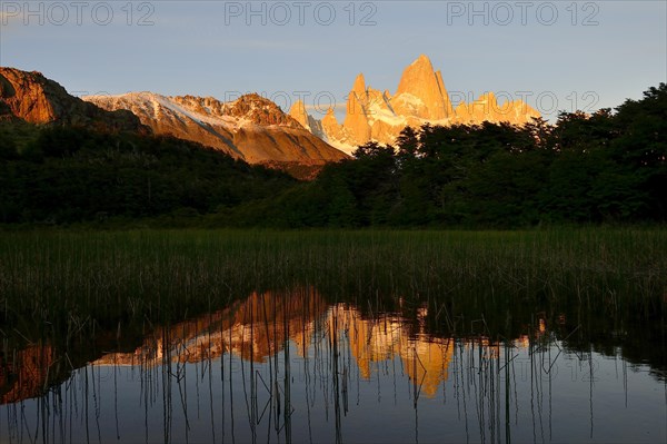 Mountain range with Cerro Fitz Roy at sunrise reflected in Lago de Los Tres