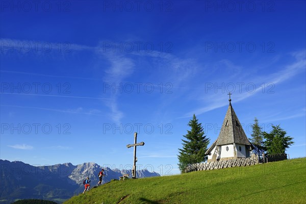 Hiker at the summit of Kraftalm with chapel