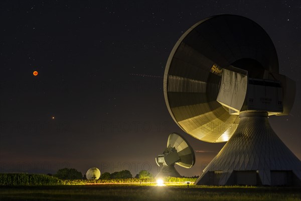 Parabolic antennas with blood moon at lunar eclipse