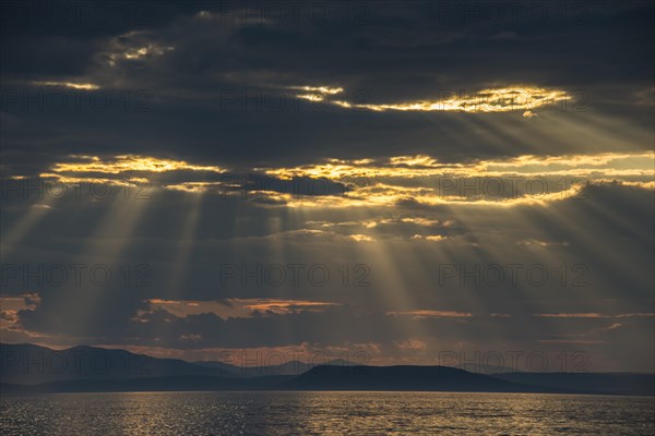 Sun breaking through the clouds above the Amur in Vladivostok