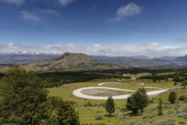 Curvy road Carretera Austral leads through green hillside