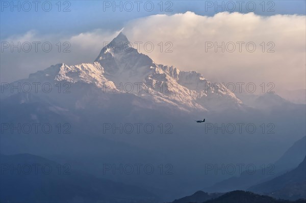 Plane flying to the sacred peak of Machhapuchhare