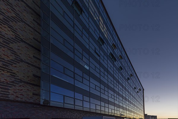 Modernized facade of the former egg cold store at dusk