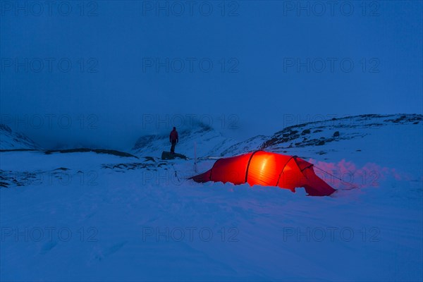 Tent with person in the snow