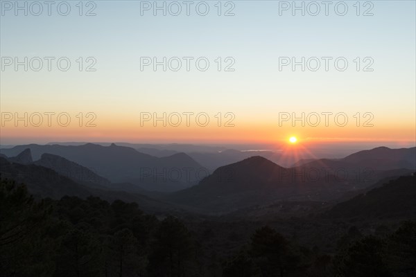 Wooded mountain landscape at sunset