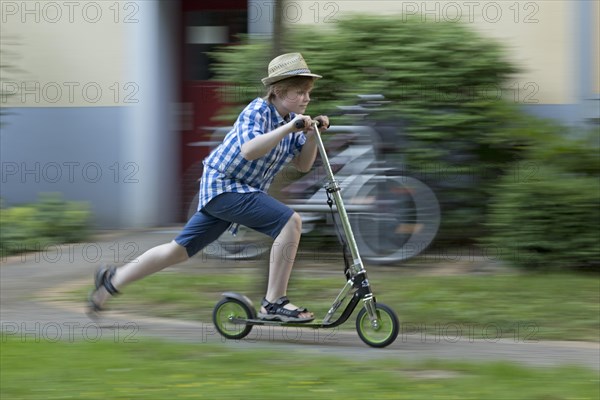 Boy is riding scooter