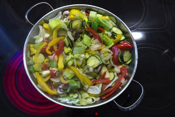 Vegetable pan on a red-hot cooktop