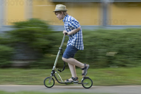 Boy is riding scooter