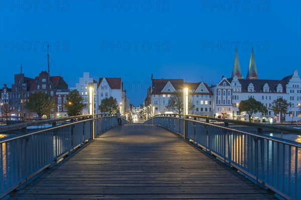 Historical houses with pedestrian bridge over the Trave