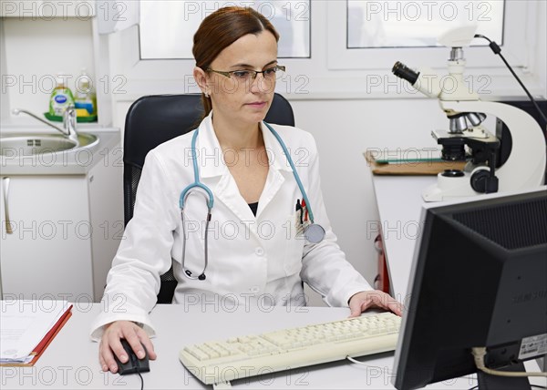 Doctor working on a computer at her desk