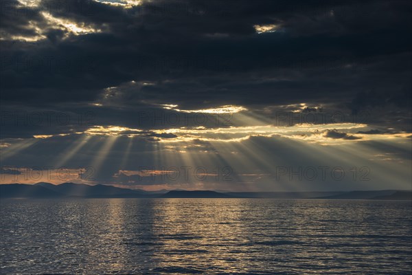 Sun breaking through the clouds above the Amur in Vladivostok