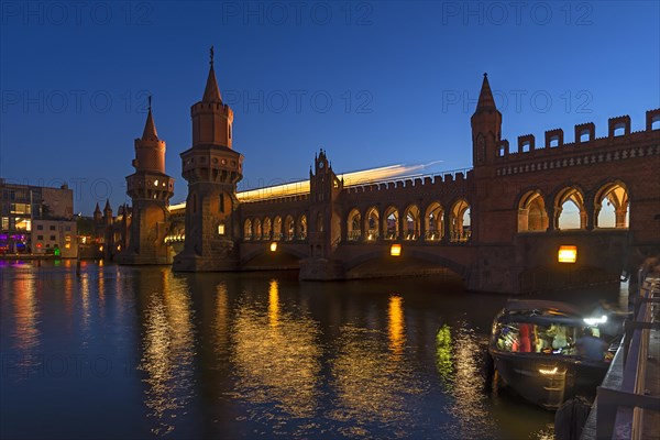 Oberbaum bridge with light traces of subway in evening light