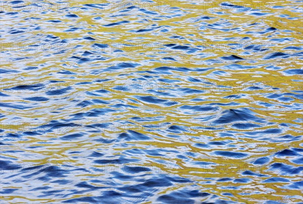 Bright colours on a water surface from a Loch in the Highlands of Scotland