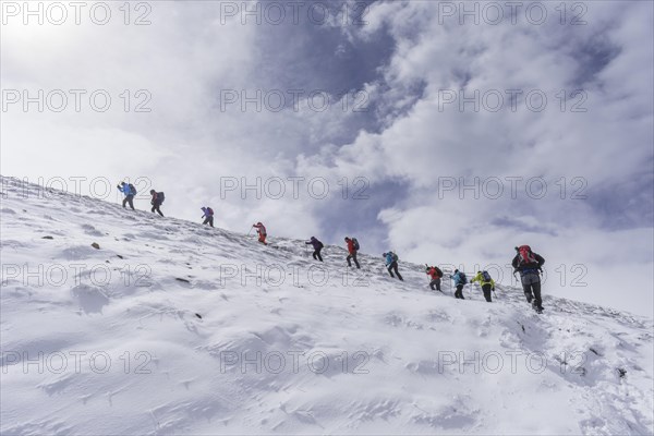 Hiking group ascending to the little Konigstuhl during fresh snowfall