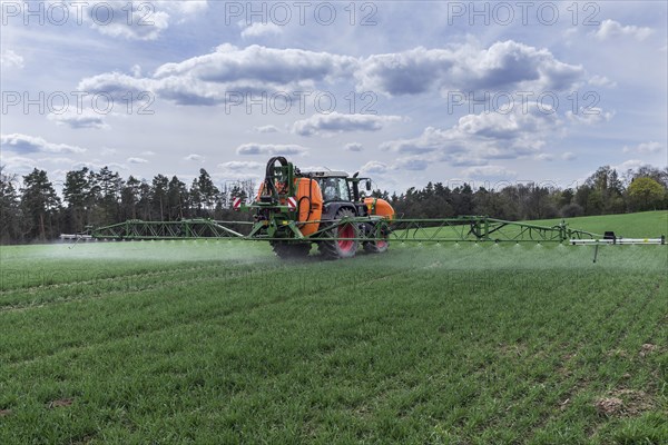 Modern high-tech sprayer in use on a germinating wheat field