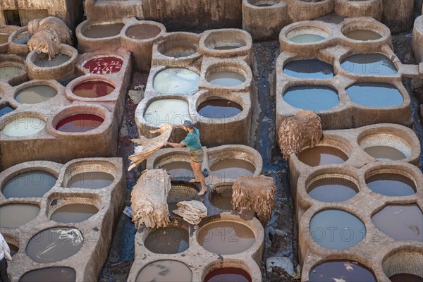 Worker dyeing leather