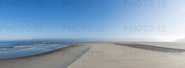 Early mist over the empty beach