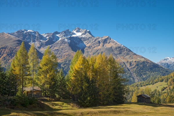 Autumnal mountain landscape with alpine huts
