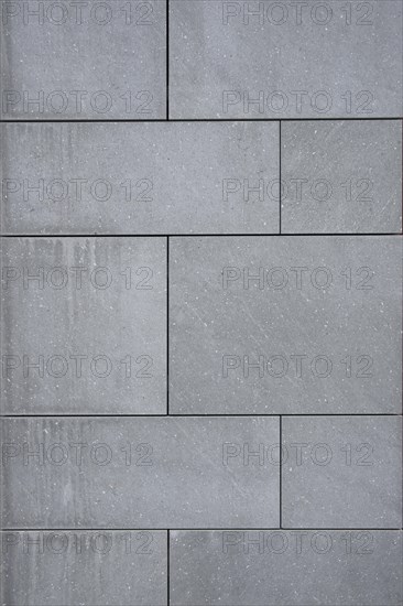 Wallcovering of large dark gray natural stone tiles