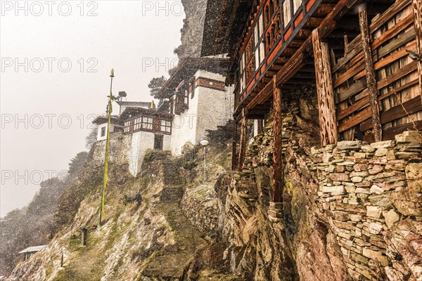 Buddhist nunnery in the mountains during snowfall