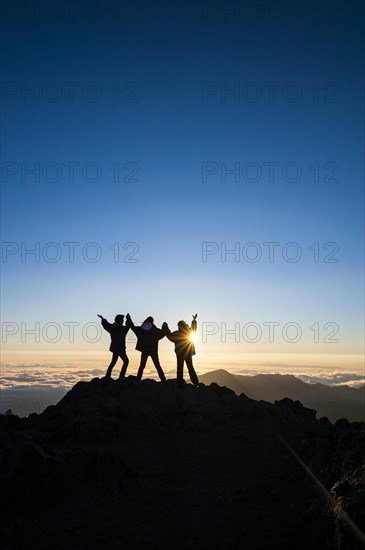 Tourists in backlight waiting for sunset on top of Haleakala National Park